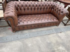 A BROWN LEATHER CHESTERFIELD THREE SEATER SETTEE