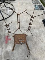A METAL STOOL AND THREE METAL SHOP DISPLAY STANDS