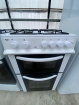 A BLACK AND WHITE GAS OVEN AND HOB