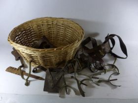 A BASKET CONTAINING A LEATHER SAM BROWNE, SWORD HOLDER, STIRRUPS ETC