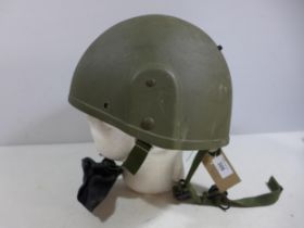 A GREEN NATO HELMET AND LINER DATED 1996