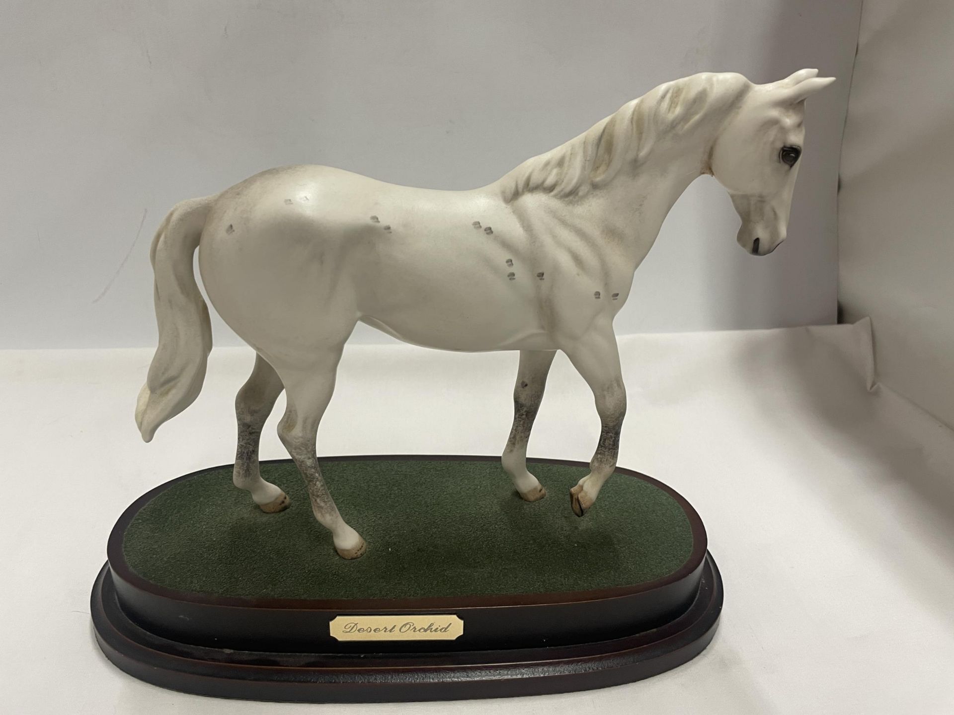 A ROYAL DOULTON DESERT ORCHID FIGURE ON A PLINTH (SECOND)