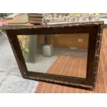 A VINTAGE LARGE HEAVY WALL MIRROR IN A WOOD AND GILT FRAME, 100CM X 75CM - FRAME IN NEED OF