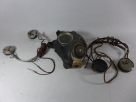 TWO WORLD WAR II RADIO HEADSETS AND A GAS MASK (3)