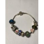 A PANDORA SILVER BRACLET WITH ELEVEN VARIOUS CHARMS