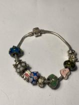 A PANDORA SILVER BRACLET WITH ELEVEN VARIOUS CHARMS