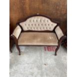 A SMALL VICTORIAN STYLE BUTTON BACK SETTEE