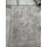 A PINK RUG WITH ORIENTAL DRAGON DESIGN