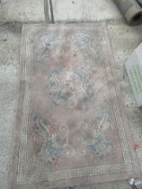 A PINK RUG WITH ORIENTAL DRAGON DESIGN