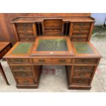 A LATE VICTORIAN WALNUT DICKENS DESK ENCLOSING EIGHT LOWER DRAWERS, SHAM DRAWER AND EIGHT DRAWERS