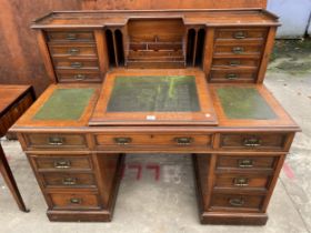 A LATE VICTORIAN WALNUT DICKENS DESK ENCLOSING EIGHT LOWER DRAWERS, SHAM DRAWER AND EIGHT DRAWERS