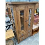 A MODERN OAK TWO DOOR DISPLAY CABINET WITH THREE DRAWERS TO BASE, 39" WIDE