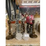 A LARGE QUANTITY OF CANDLESTICKS TO INCLUDE WOODEN, METAL AND GLASS