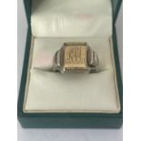 A GENTS SILVER AND GOLD SIGNET RING