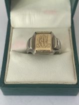 A GENTS SILVER AND GOLD SIGNET RING