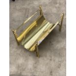 A DECORATIVE BRASS LOG RACK