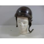 A MILITARY TANKERS HELMET AND LINER, THE INSIDE MARKED PRODUCTION STAR HOLLYWOOD DEPOSE FRANCE