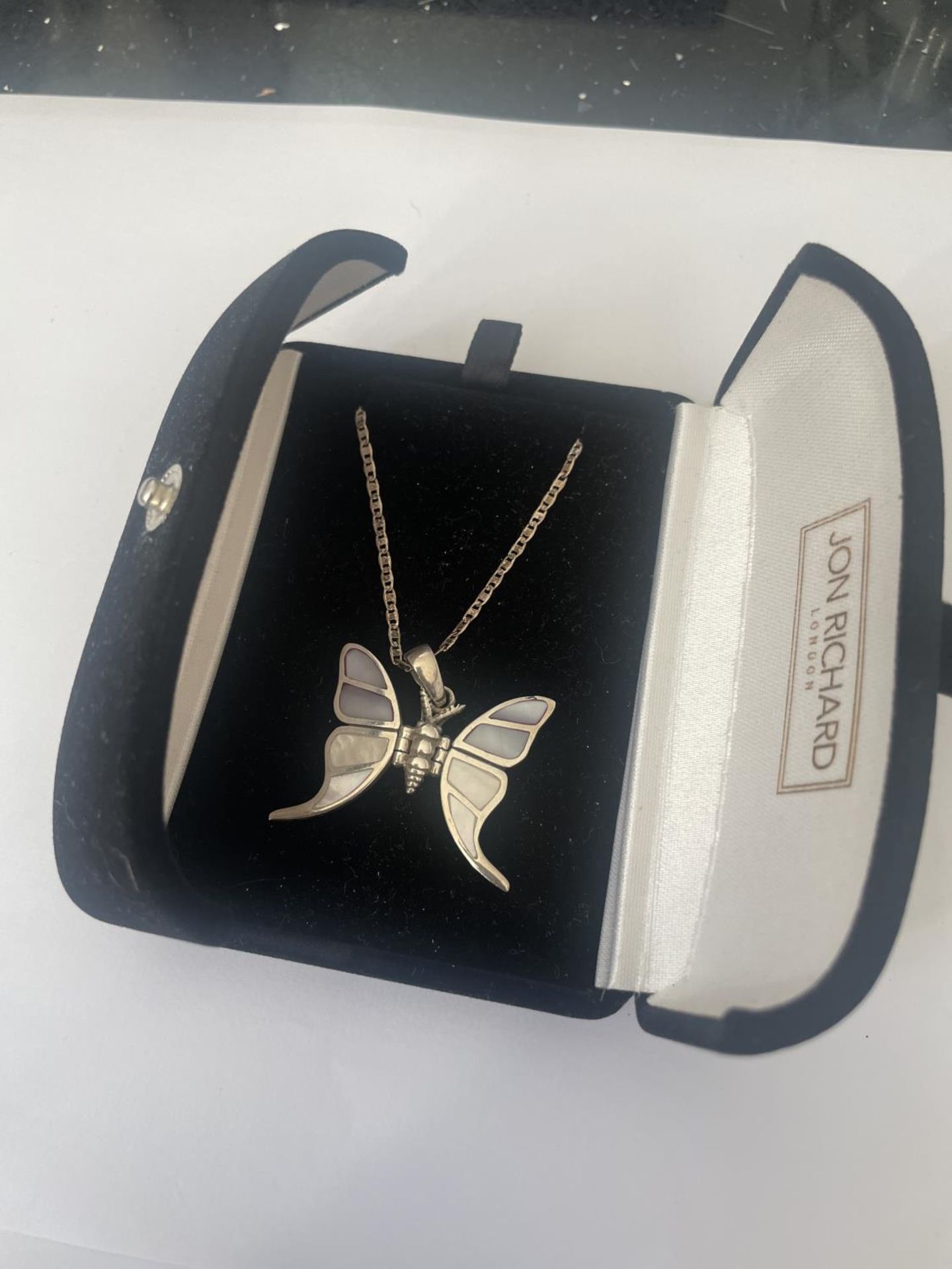 A BOXED SILVER BUTTERFLY NECKLACE