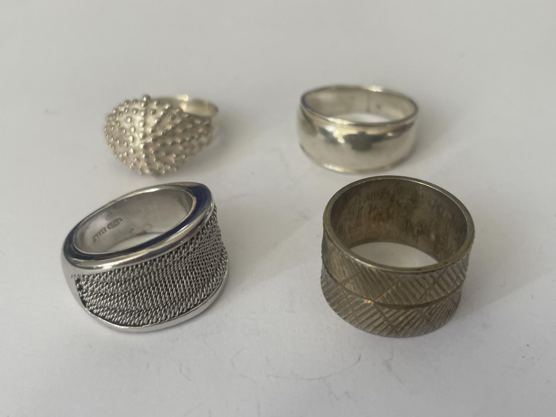 FOUR ASSORTED SILVER RINGS