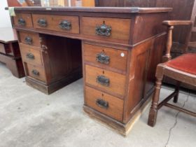 A LATE VICTORIAN TWIN-PEDESTAL DESK ENCLOSING NINE DRAWERS, 48 X 26" BEARING LABEL 'PARK LANE