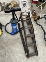 A PAIR OF METAL CAR RAMPS AND A PUMP