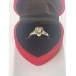 A BOXED SILVER AND PERIDOT RING