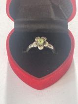 A BOXED SILVER AND PERIDOT RING