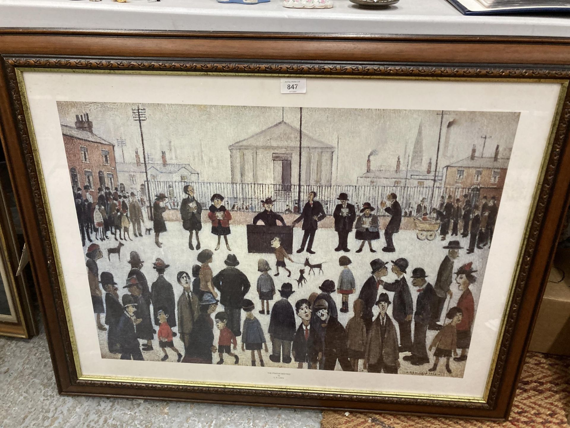 A LARGE L S LOWRY PRINT 'THE PRAYER MEETING', 92CM X 72CM