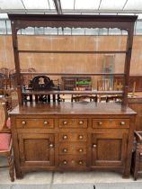 A GEORGE III OAK DRESSER ENCLOSING SIX DRAWERS AND TWO CUPBOARDS, 59" WIDE COMPLETE WITH PLATE RACK