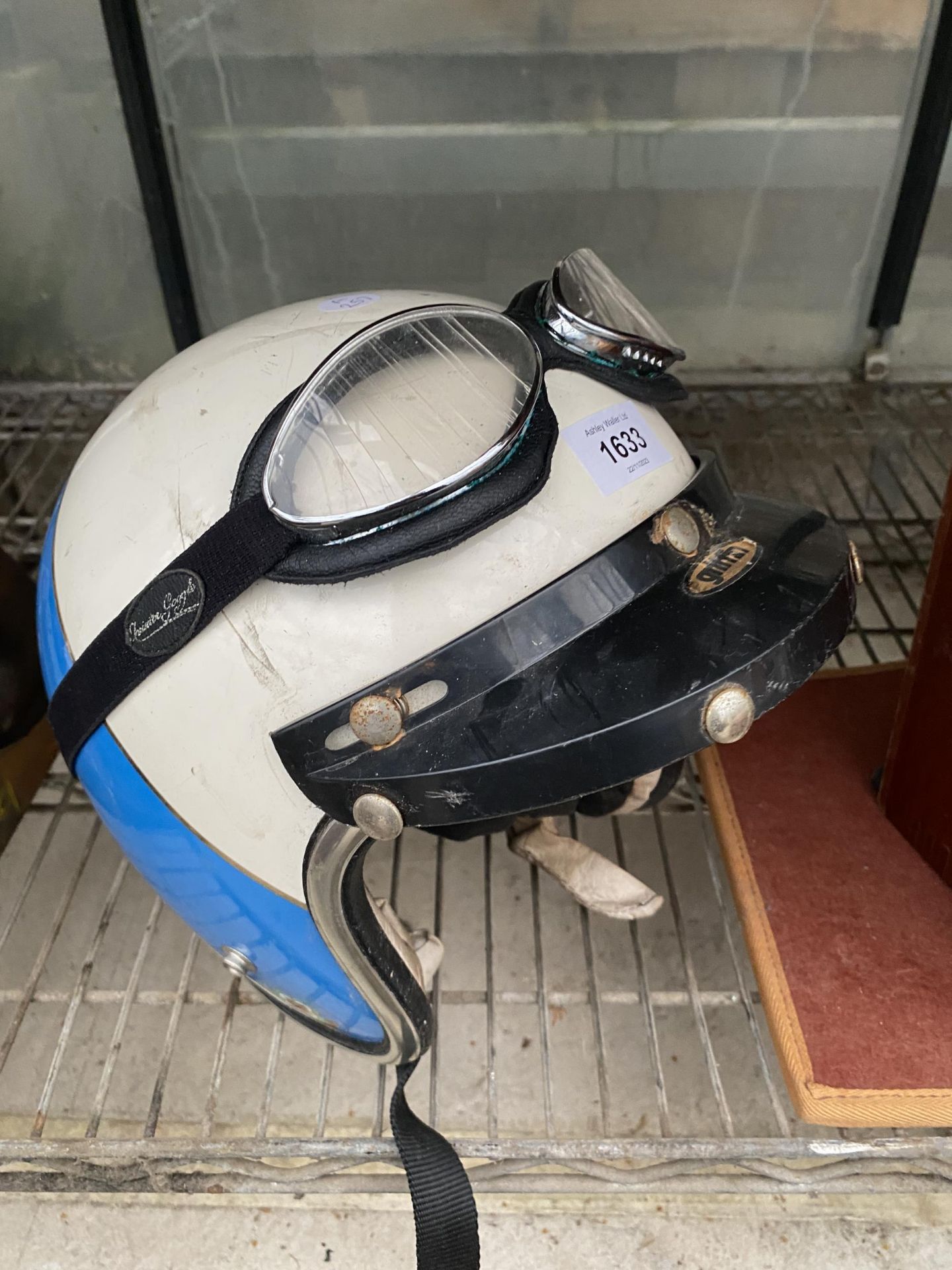 A VINTAGE MOTORBIKE HELMET AND GOGGLES