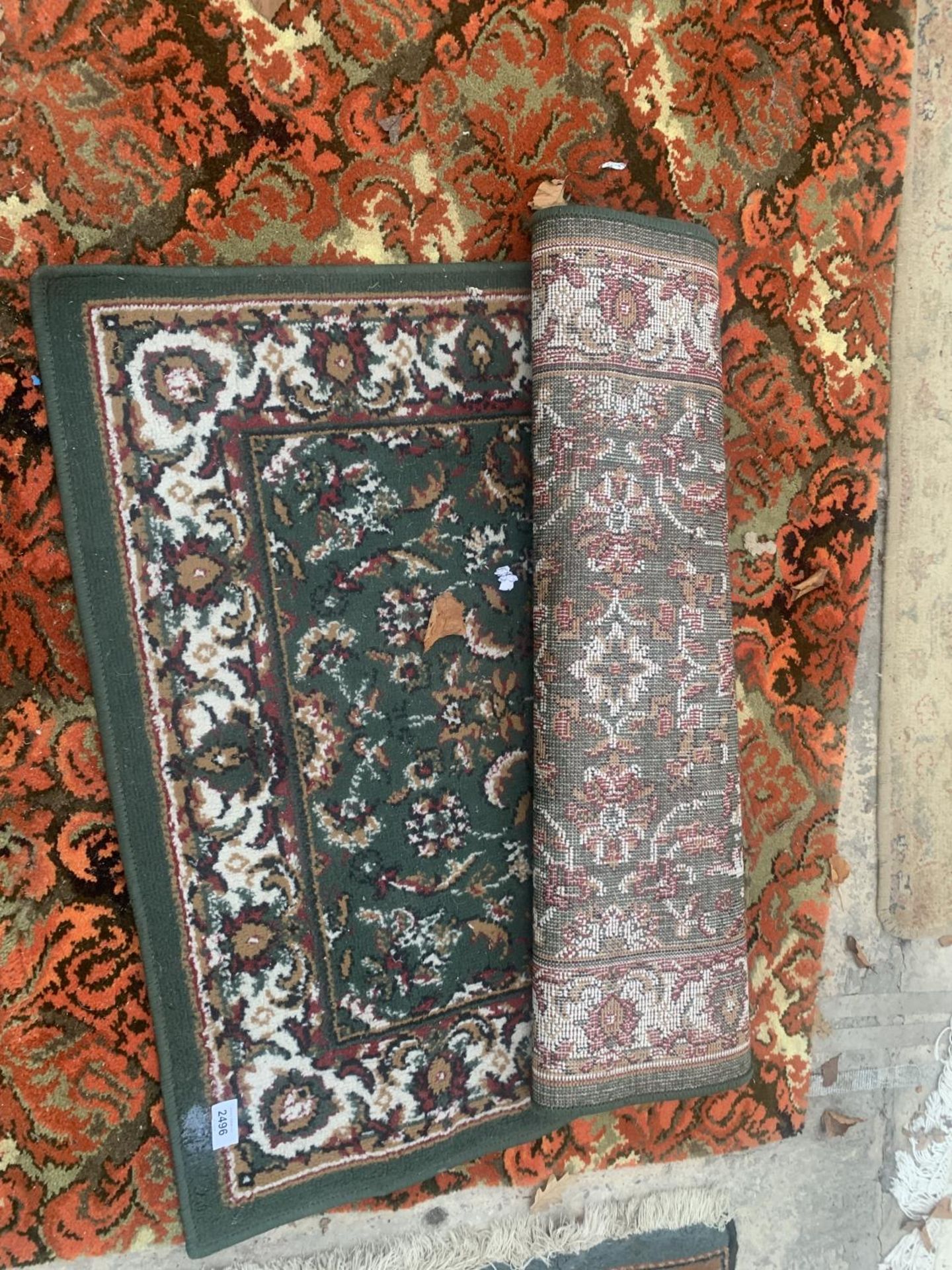 A GREEN PATTERNED RUG AND AN ORANGE PATTERNED RUG - Image 2 of 2