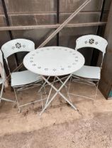 A MODERN METALWARE PAINTED FOLDING PATIO TABLE AND TWO CHAIRS