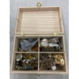 A WOODEN BOX CONTAINING A QUANTITY OF COSTUME JEWELLERY TO INCLUDE WATCHES, BRACELETS, NECKLACES,