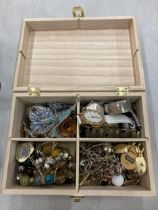 A WOODEN BOX CONTAINING A QUANTITY OF COSTUME JEWELLERY TO INCLUDE WATCHES, BRACELETS, NECKLACES,