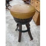 A 15" DIAMETER BARREL STOOL ON SPLAY LEGS WITH METAL BANDING AND LEATHER TOP