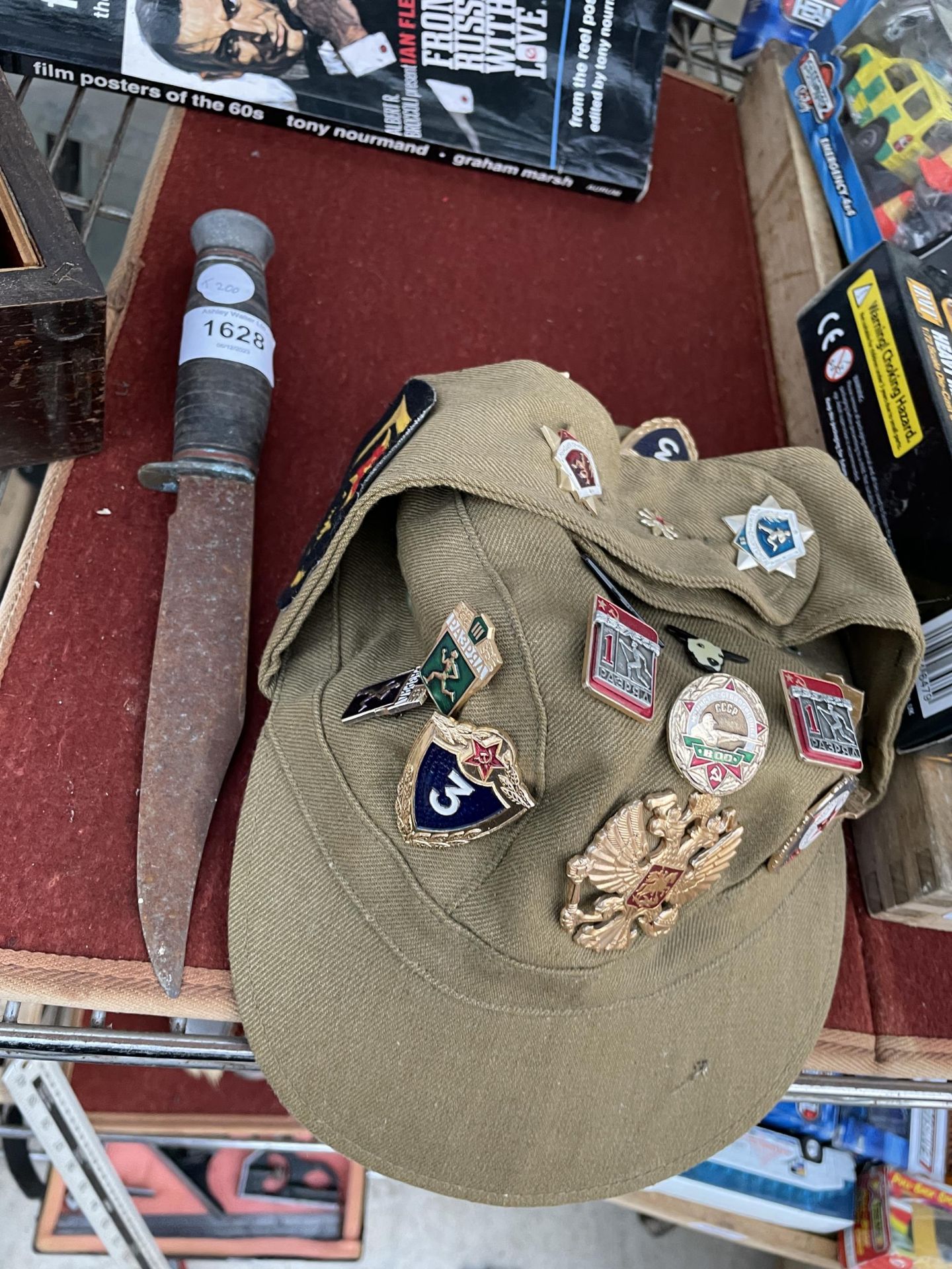 A MILITARY CAP WITH VARIOUS BADGES AND A FURTHER KNIFE
