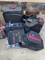 A LARGE ASSORTMENT OF SUITCASES, HOLDALLS AND TRAVEL CASES ETC