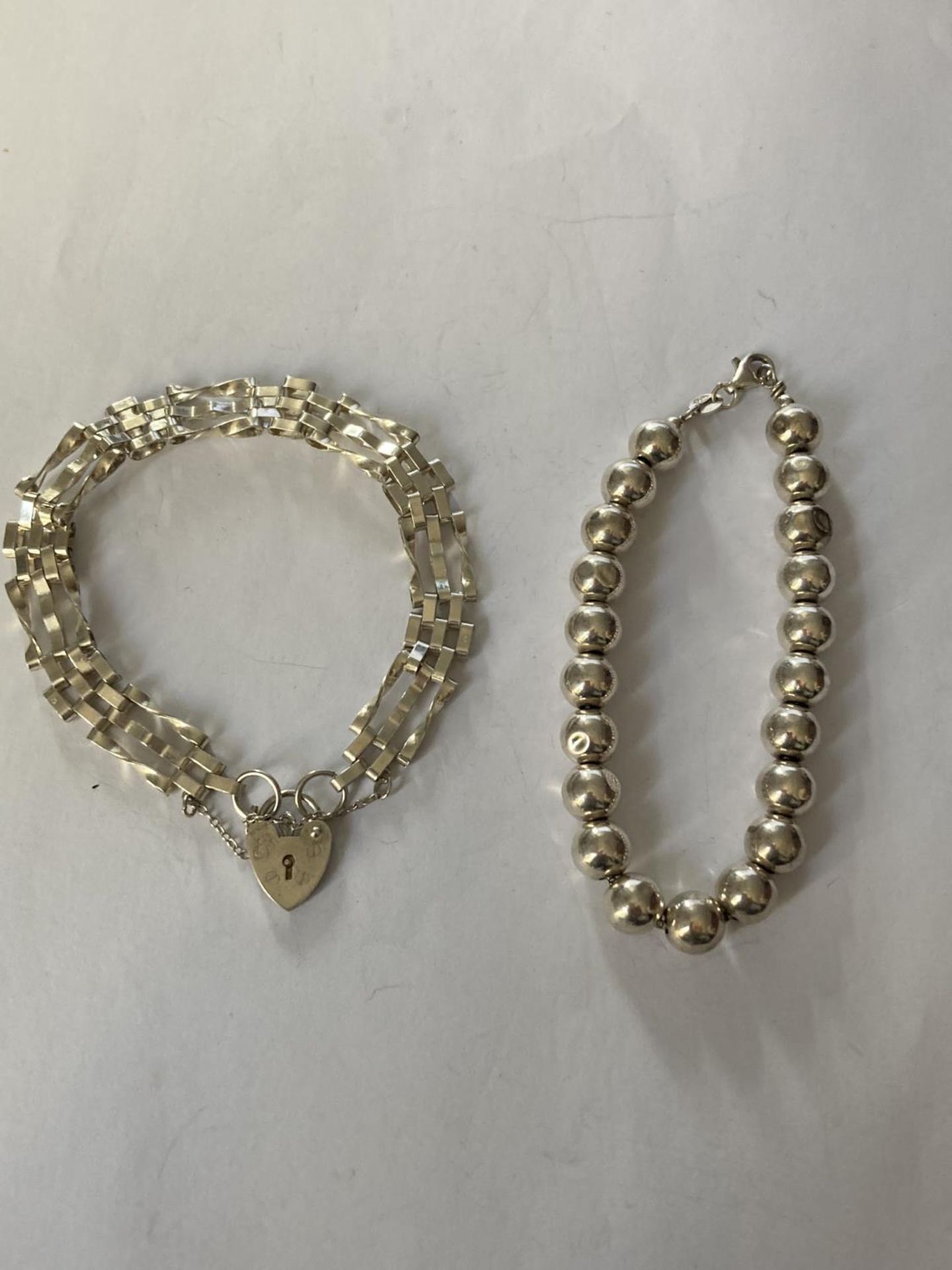 TWO SILVER BRACELETS (BEADS NOT SILVER ONLY THE CHAIN)