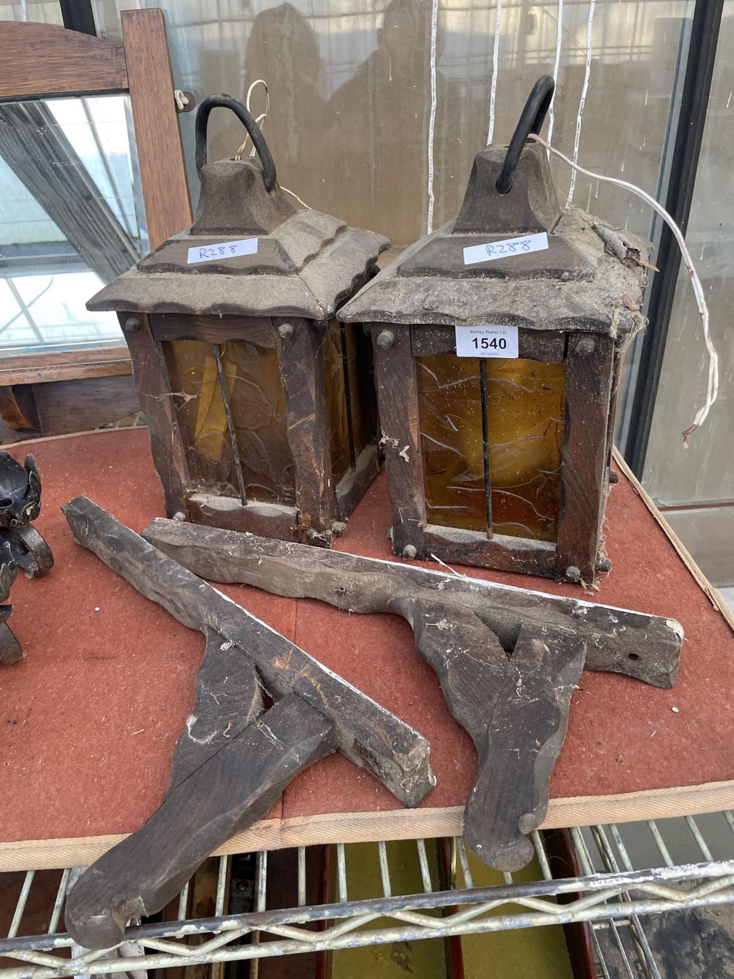 A PAIR OF OAK LANTERNS WITH YELLOW GLASS AND WALL HANGING BRACKETS