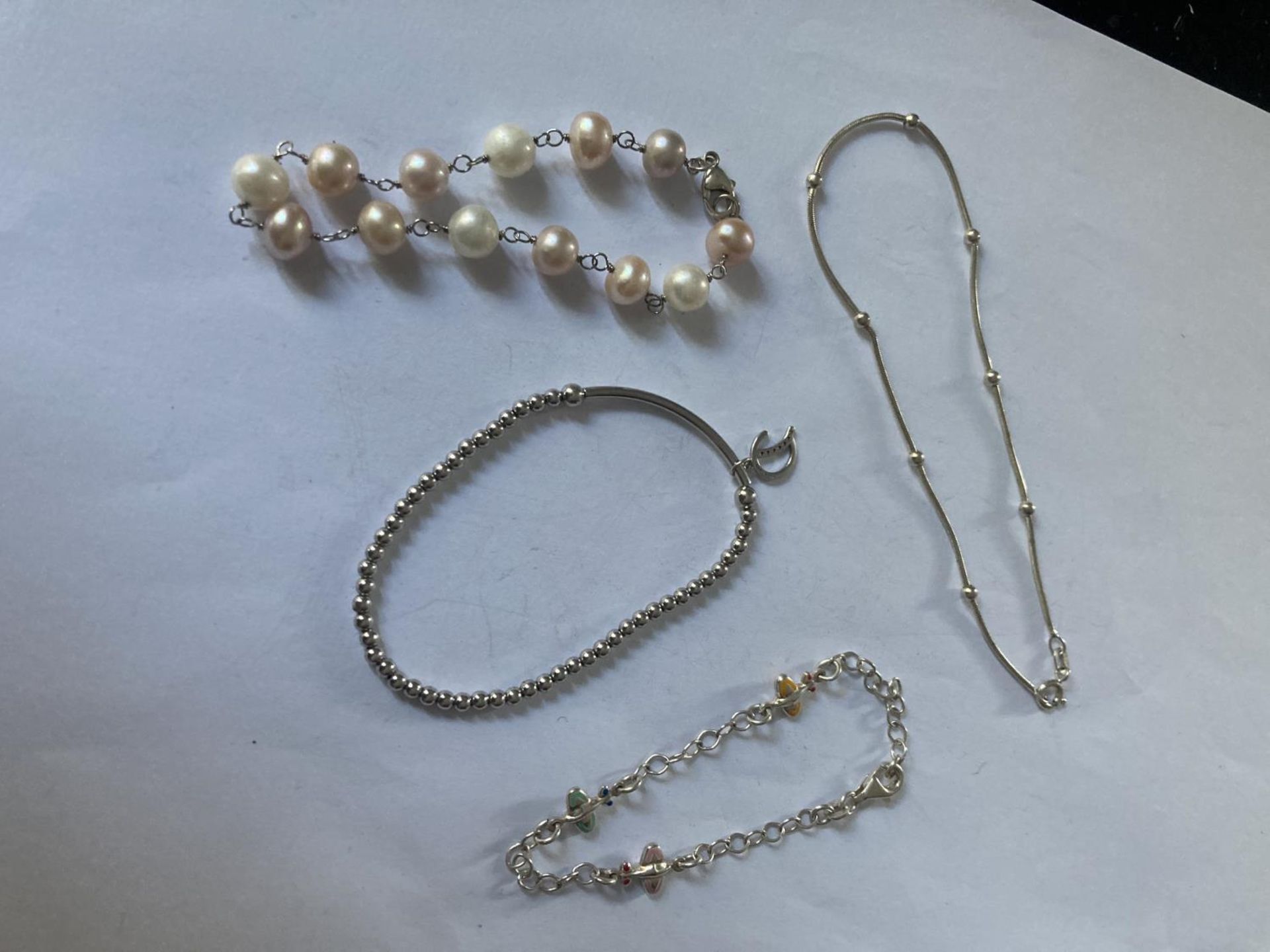 FOUR ASSORTED SILVER BRACELETS