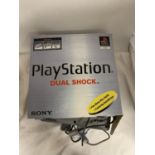 A BOXED SONY PLAYSTATION ONE DUAL SHOCK CONSOLE WITH TWO CONTROLLERS