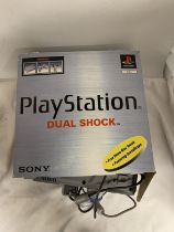 A BOXED SONY PLAYSTATION ONE DUAL SHOCK CONSOLE WITH TWO CONTROLLERS