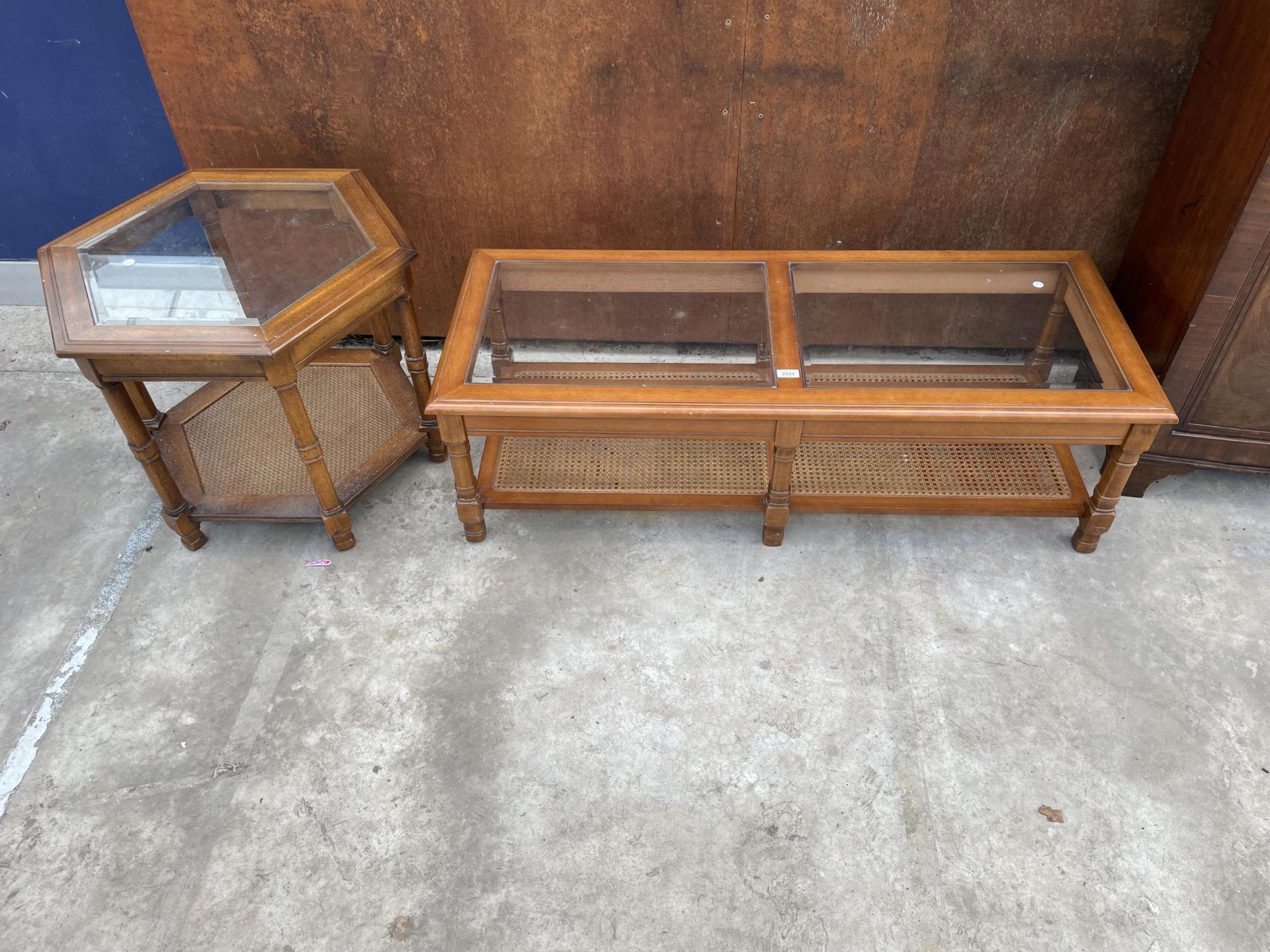 A TWO TIER COFFEE TABLE WITH INSET GLASS TOP AND CANE LOWER SHELF, 50 X 21" AND MATCHING HEXAGONAL