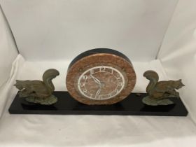 A CONTINENTAL ART DECO CLOCK ON A PLINTH WITH SQUIRREL GARNITURES 23" WIDE