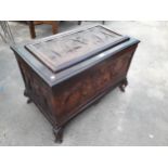 AN ORIENTAL HARDWOOD BLANKET CHEST PROFUSELY CARVED WITH ELEPHANTS AND TREES, COMPLETE WITH LIFT-OUT