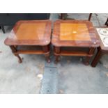 A PAIR OF BURR WALNUT LAMP TABLES WITH CANE MAGAZINE SHELF