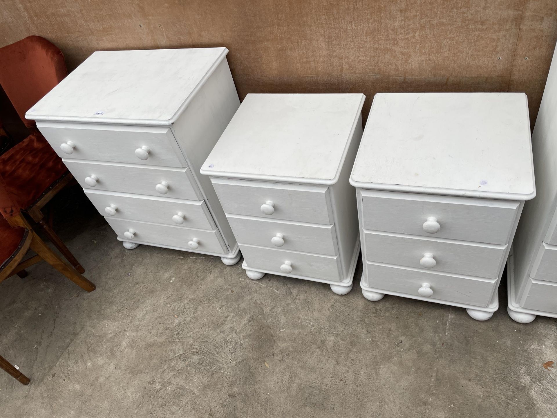 A PAINTED WHITE CHEST OF FOUR DRAWERS AND A PAIR OF BEDSIDE CHESTS