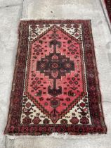 A SMALL RED PATTERENED RUG