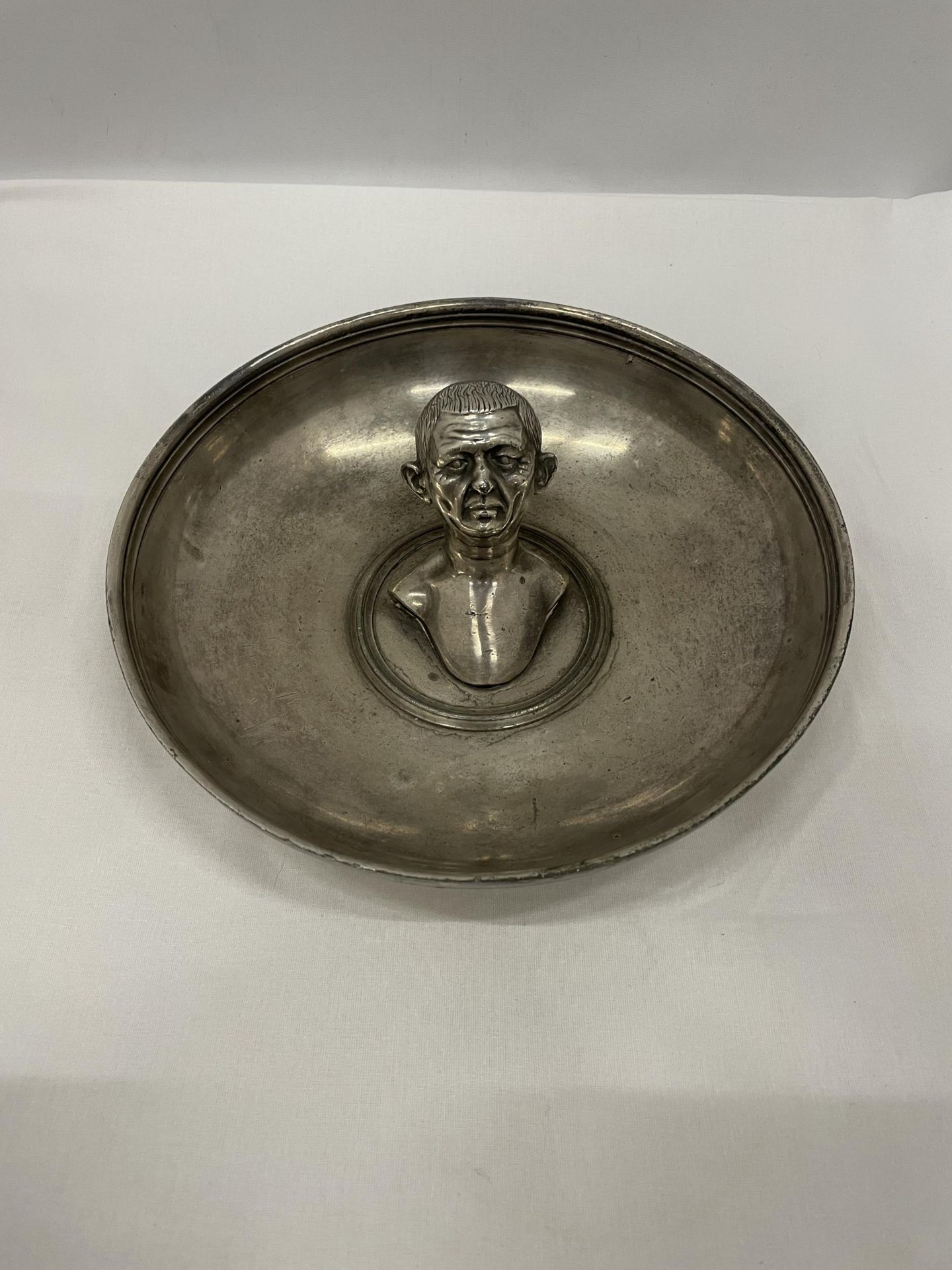 A REPLICA OF THE ROMAN BOSCOREALE TREASURE DISH WITH THE BUST OF A MAN INSIDE