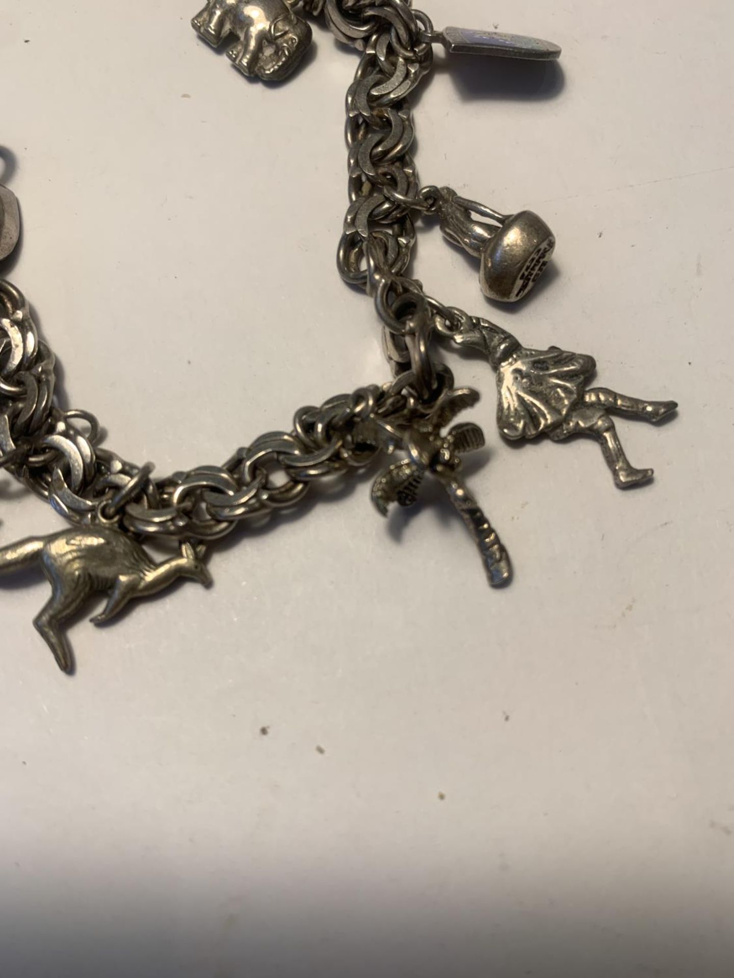 A SILVER CHARM BRACELET WITH TEN CHARMS - Image 3 of 4